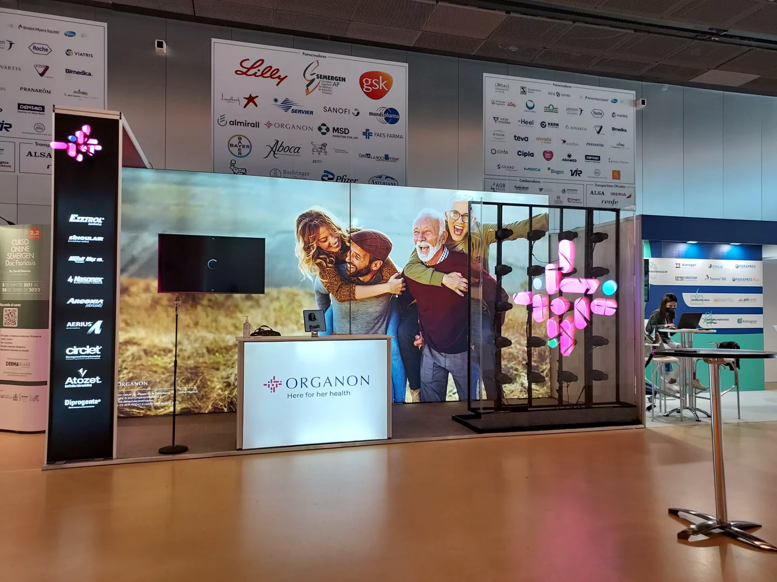 Stand de Organon con mostrador iluminado, holograma y gráfica de gran formato